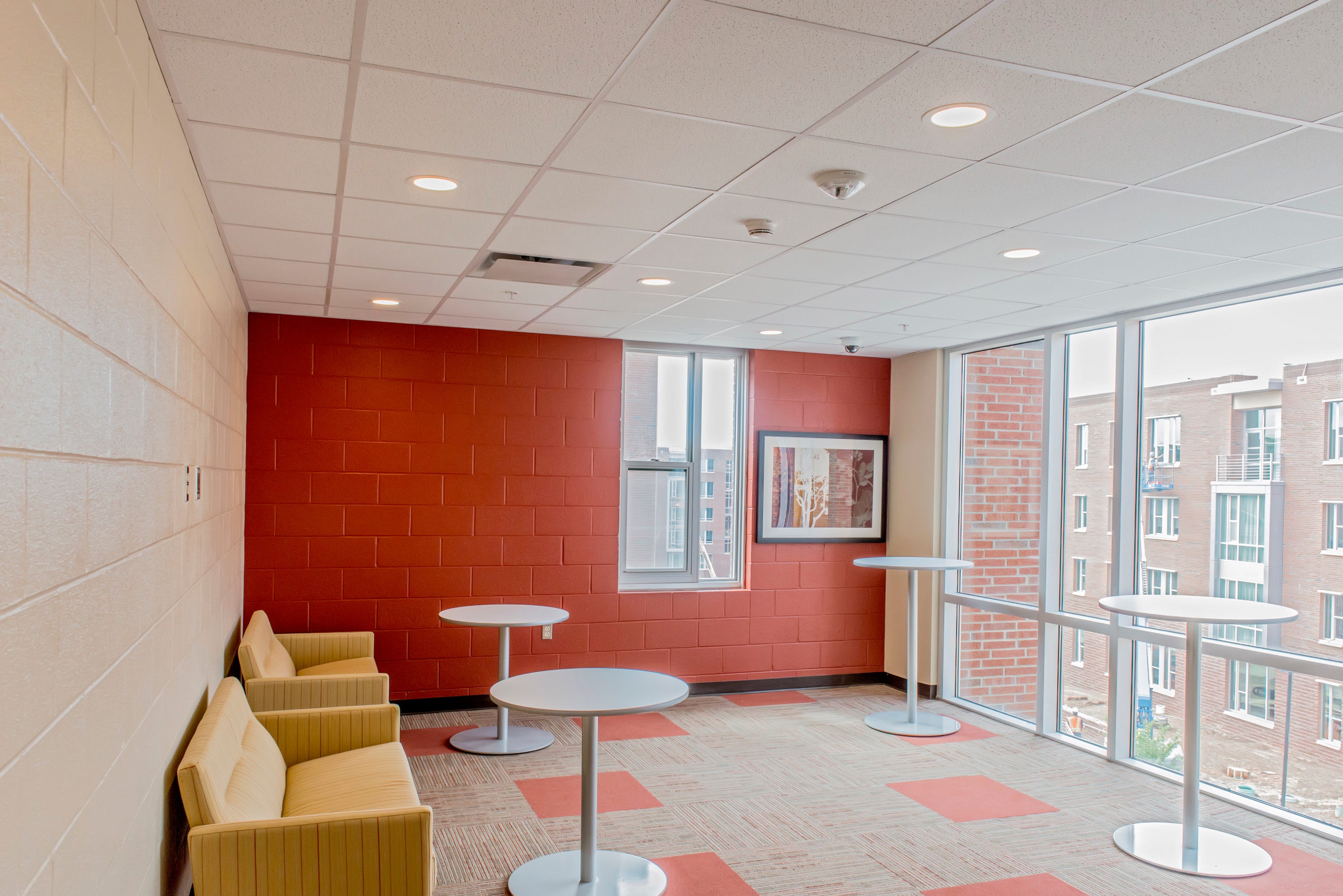 A lounge area with recessed lighting in the ceiling.