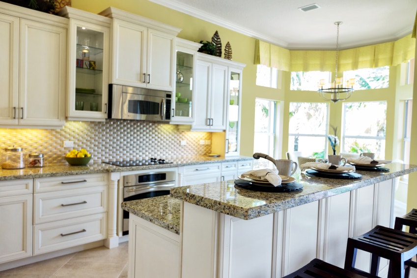 A kitchen with under cabinet recessed lighting.